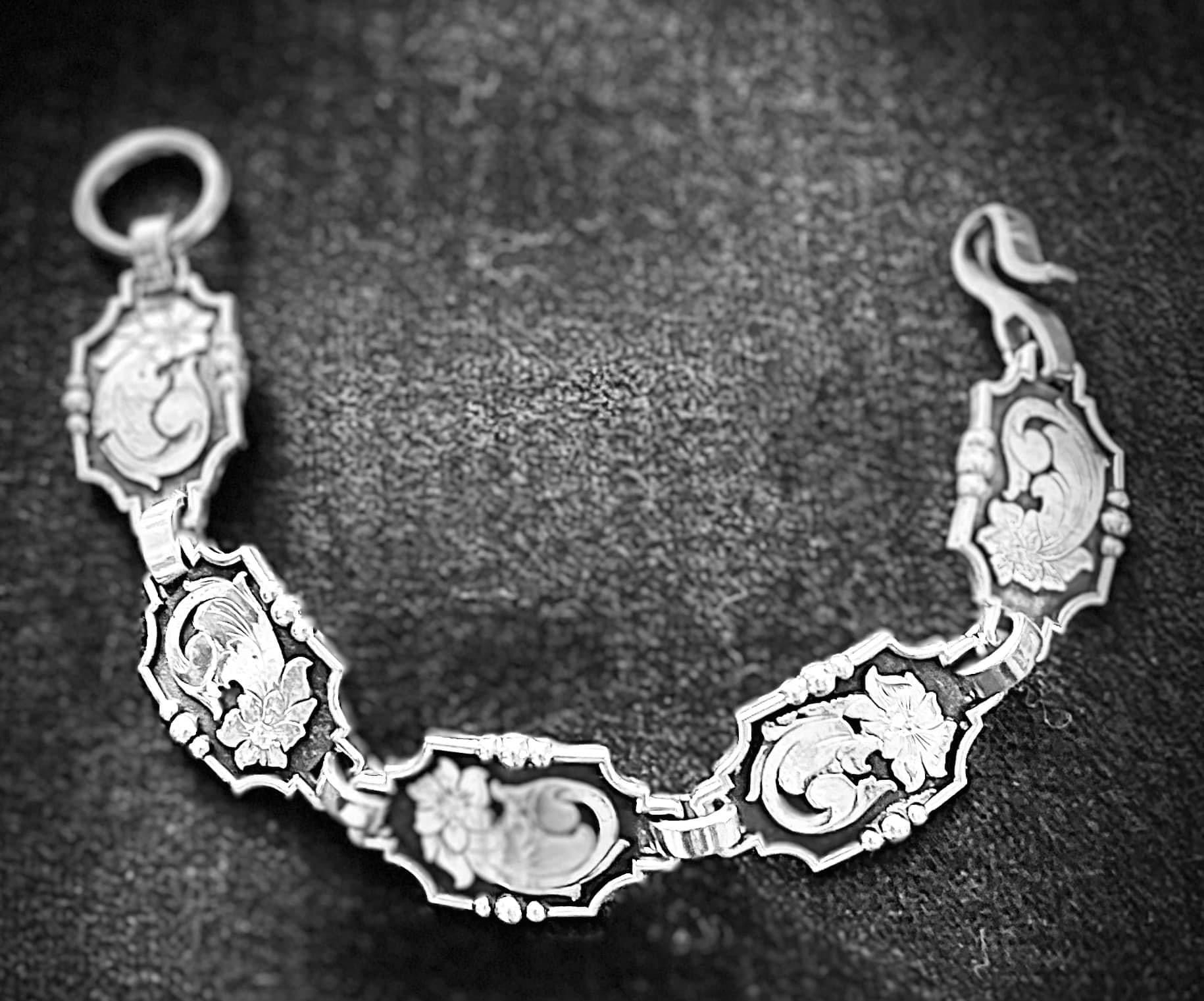 Sterling silver, hand engraved, .05 diamond in each link (5 links).    Price may vary with stone.   CUSTOM ORDER