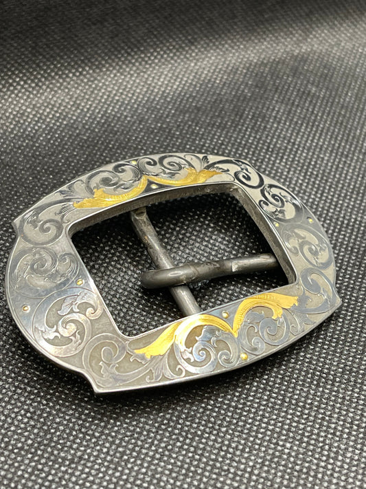 Hand engraved steel buckle, blued finish with and 24K gold inlay.  Fits 1” Belt